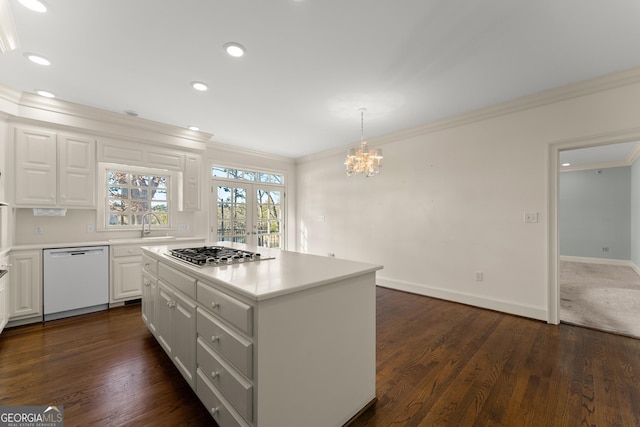 kitchen with dishwasher, white cabinets, hanging light fixtures, a center island, and stainless steel gas cooktop