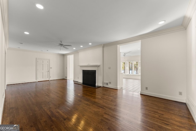 unfurnished living room featuring dark wood-type flooring, ceiling fan, and ornamental molding