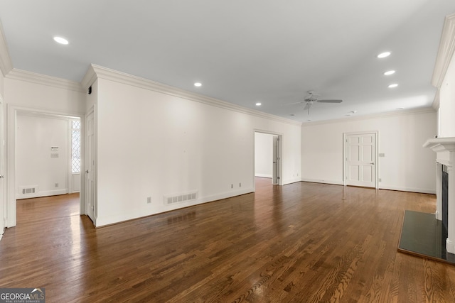 unfurnished living room with crown molding, ceiling fan, and dark hardwood / wood-style floors