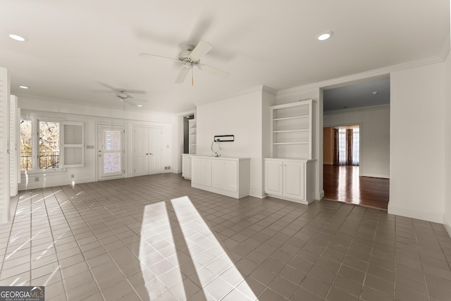 unfurnished living room featuring ceiling fan, ornamental molding, and tile patterned floors