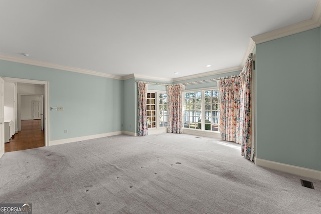 carpeted spare room with crown molding