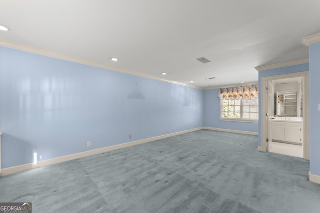 empty room with crown molding and carpet flooring