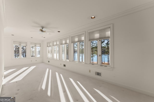 unfurnished sunroom featuring a wealth of natural light and ceiling fan