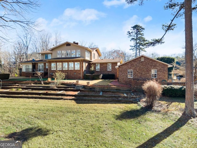 rear view of property with a yard