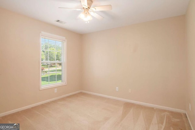 unfurnished room with ceiling fan and light carpet