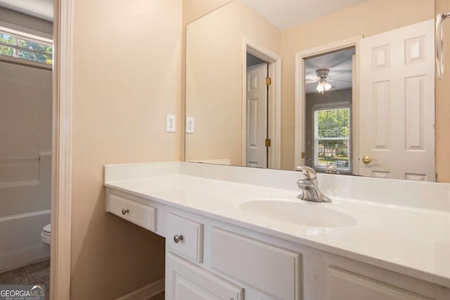 full bathroom featuring toilet, tile patterned floors, ceiling fan, shower / tub combination, and vanity