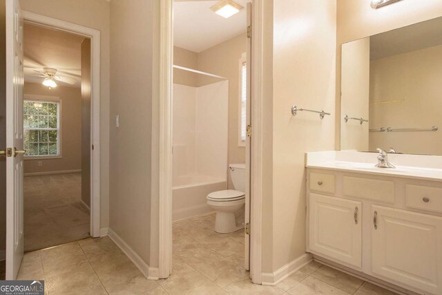 full bathroom featuring washtub / shower combination, toilet, tile patterned floors, vanity, and ceiling fan