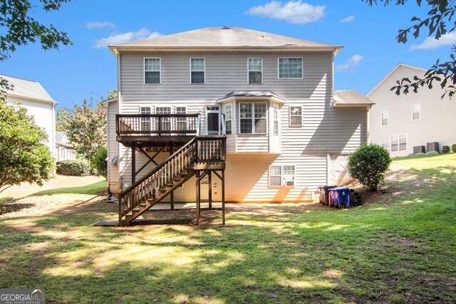 back of house featuring central AC, a yard, and a wooden deck