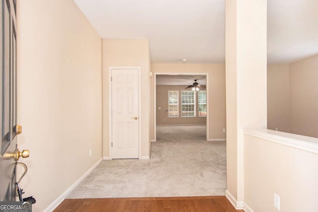 hall featuring light colored carpet