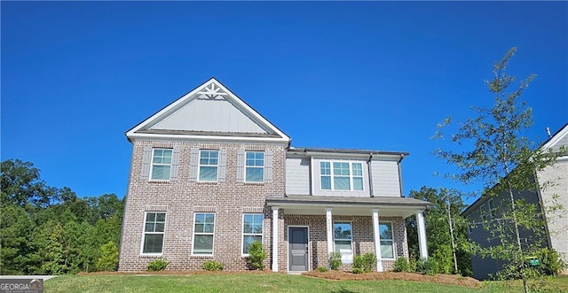 view of front of home featuring a front yard and a porch