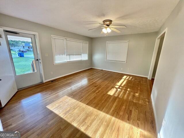 empty room featuring hardwood / wood-style floors and ceiling fan