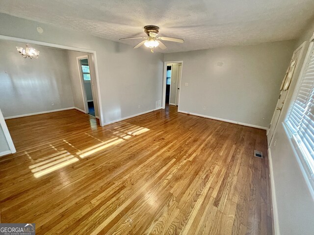 spare room with hardwood / wood-style flooring, a textured ceiling, and ceiling fan