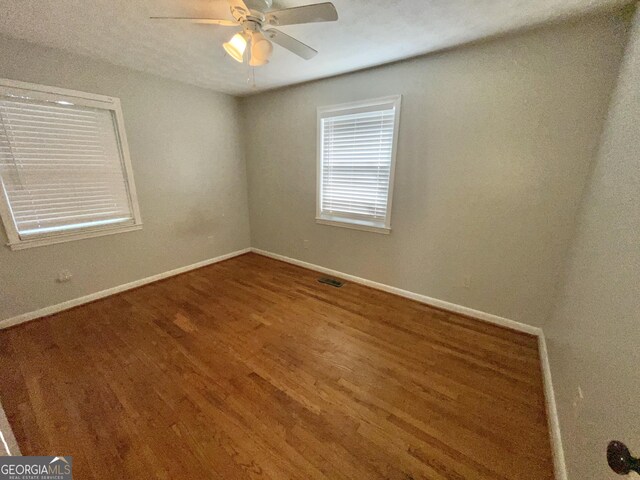 unfurnished bedroom featuring hardwood / wood-style floors and ceiling fan