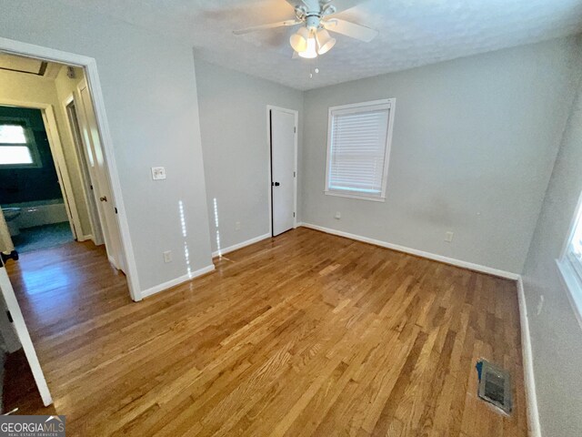 spare room with ceiling fan and dark hardwood / wood-style flooring