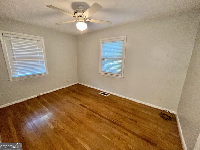 unfurnished bedroom with ceiling fan and hardwood / wood-style floors