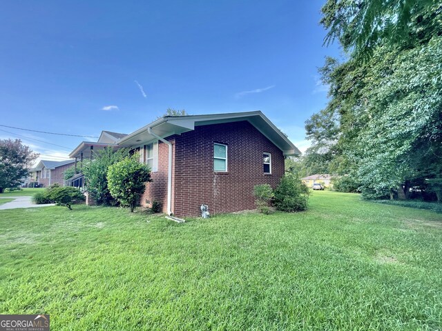 view of property exterior with a lawn