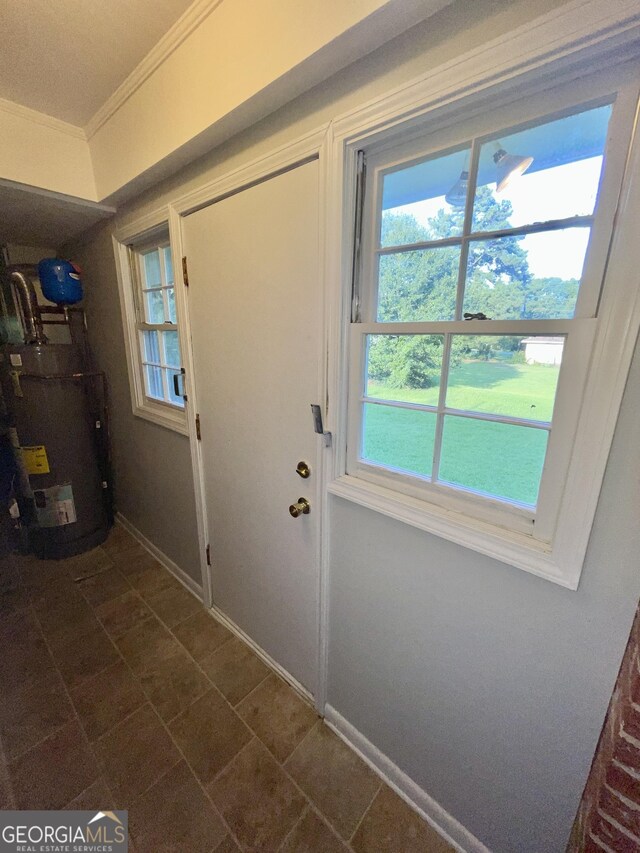 doorway to outside featuring ornamental molding and water heater