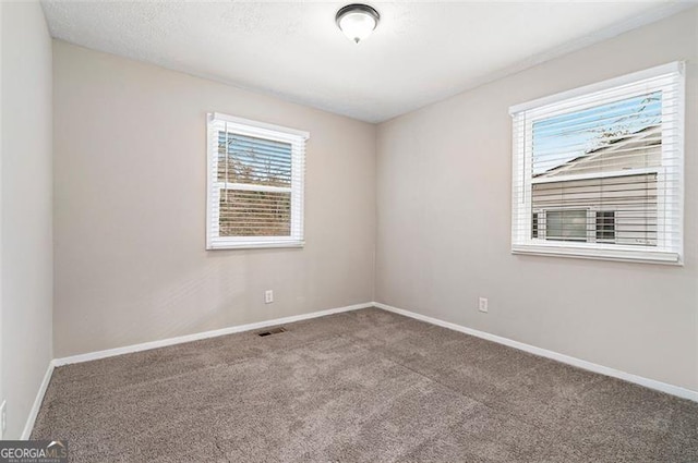 empty room featuring carpet flooring