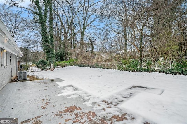 yard layered in snow with central air condition unit