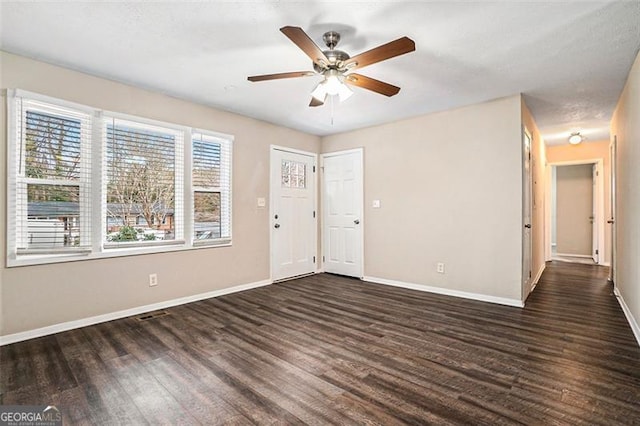 unfurnished room featuring ceiling fan and dark hardwood / wood-style floors