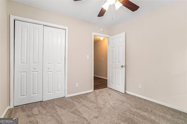 unfurnished bedroom featuring ceiling fan, a closet, and light carpet