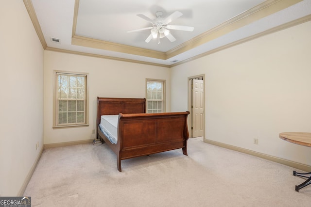 bedroom with visible vents, multiple windows, and a raised ceiling