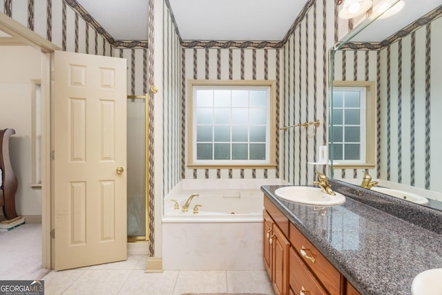 bathroom with plus walk in shower, tile patterned floors, and vanity