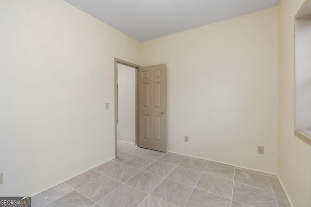 spare room with light tile patterned floors