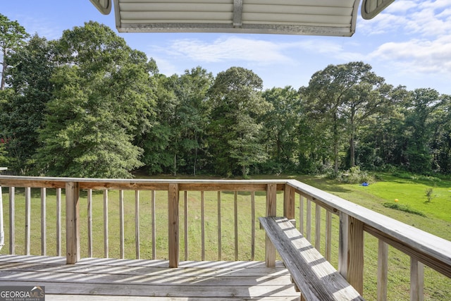 wooden terrace with a lawn