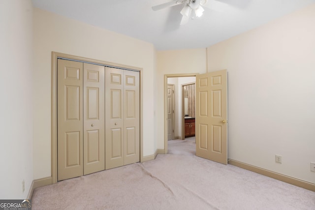 bedroom featuring baseboards, ceiling fan, a closet, and light colored carpet