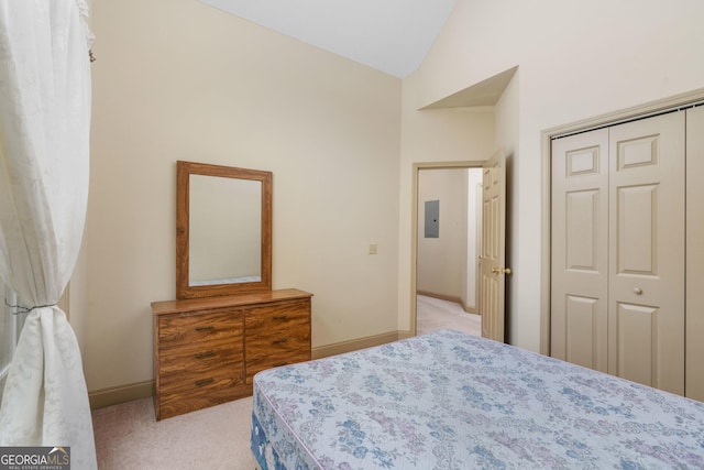 carpeted bedroom with a closet, baseboards, lofted ceiling, and electric panel