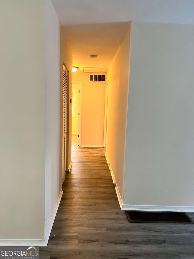 hallway with dark hardwood / wood-style floors