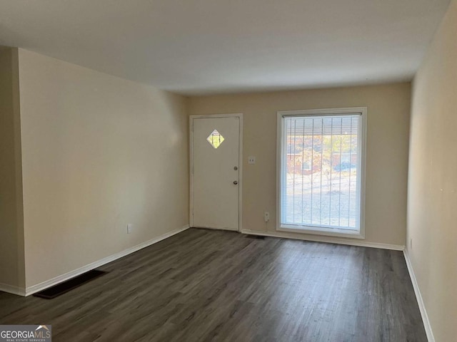 entryway with dark wood-type flooring