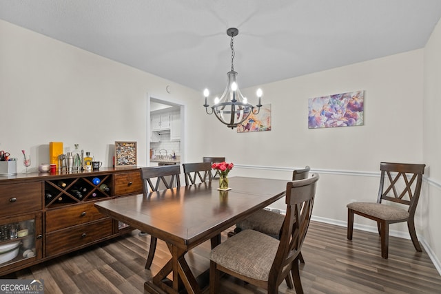 dining room featuring an inviting chandelier and dark hardwood / wood-style flooring