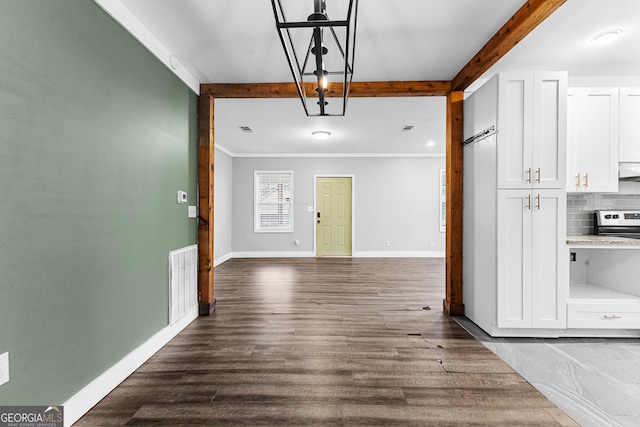 interior space featuring crown molding, beamed ceiling, and dark hardwood / wood-style floors