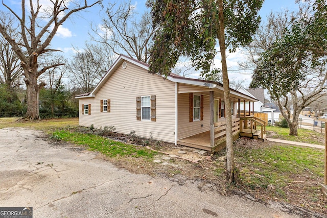 view of property exterior featuring covered porch