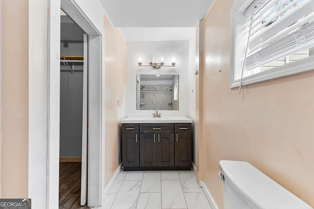 bathroom with a wealth of natural light, vanity, and toilet