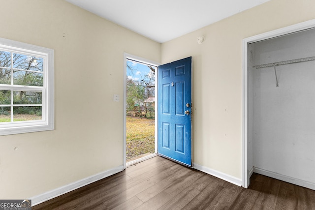 unfurnished bedroom featuring a closet and dark hardwood / wood-style floors