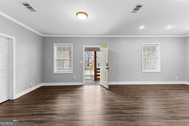 empty room with crown molding and dark hardwood / wood-style flooring