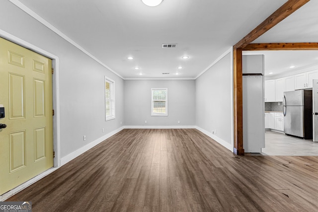 unfurnished living room featuring crown molding and light hardwood / wood-style flooring