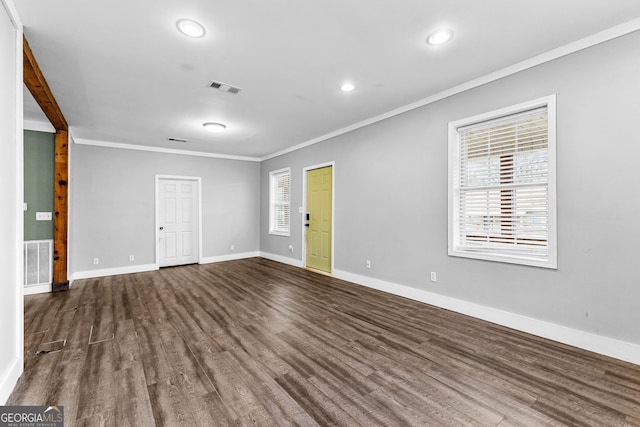 empty room with crown molding and dark hardwood / wood-style floors