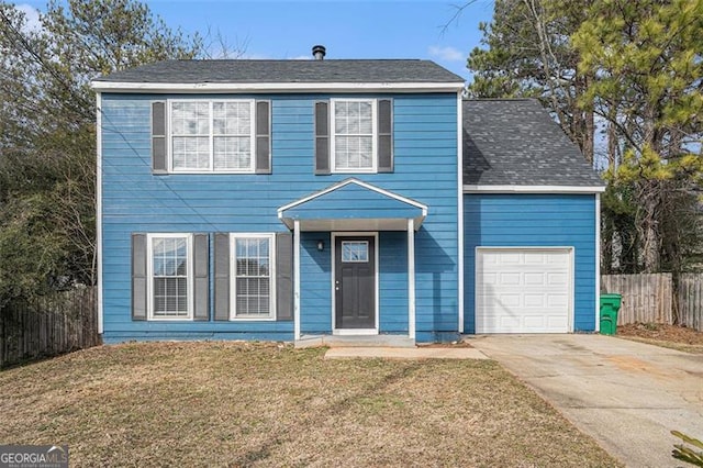 view of front of house featuring a front yard and a garage