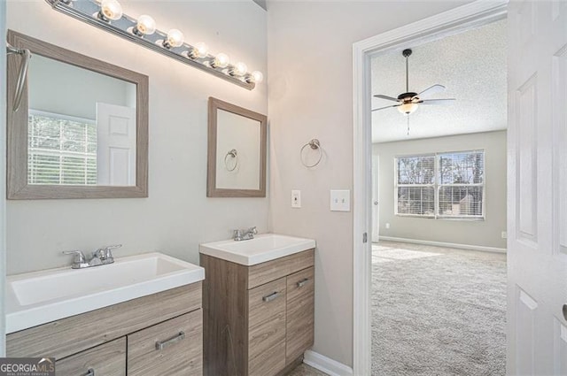 bathroom featuring vanity, a textured ceiling, and ceiling fan