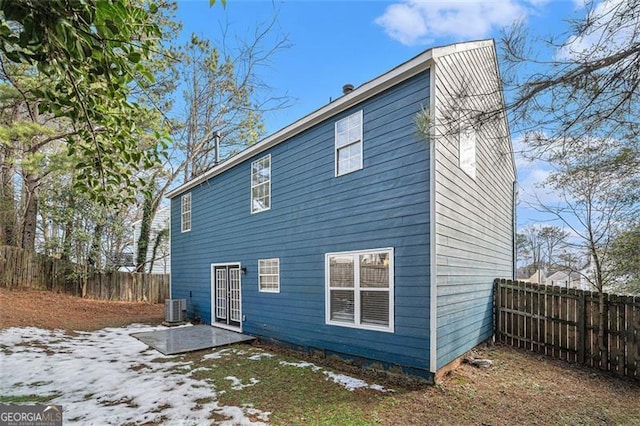 snow covered property featuring central air condition unit