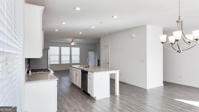 kitchen with white cabinetry, ceiling fan with notable chandelier, a center island with sink, pendant lighting, and appliances with stainless steel finishes