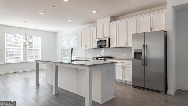 kitchen featuring sink, white cabinetry, an island with sink, and appliances with stainless steel finishes