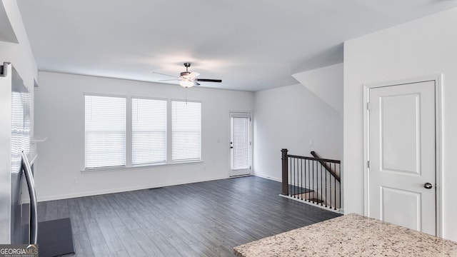 entrance foyer with ceiling fan and dark wood-type flooring