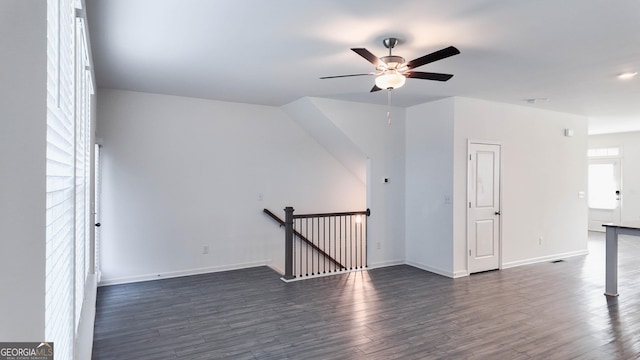 additional living space with ceiling fan and dark wood-type flooring