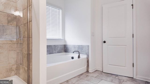 bathroom with tile patterned floors and independent shower and bath