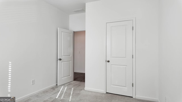 unfurnished bedroom featuring light carpet